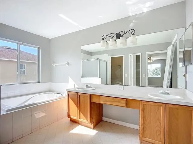 a living room with a bed and next to a window