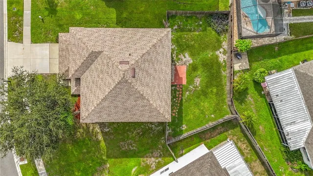 an aerial view of residential houses with outdoor space and street view