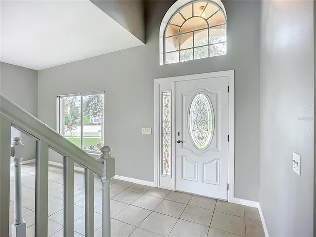 a view of an entryway with wooden floor and door