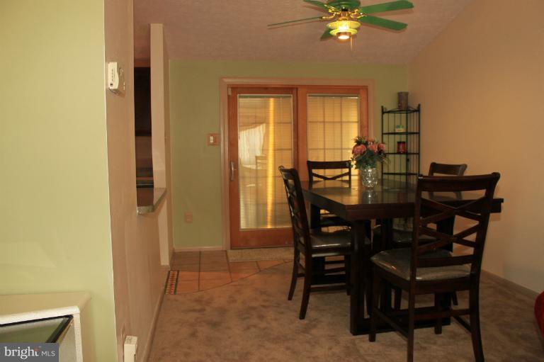 62 Yew Road Baltimore, MD 21221 - Photo 8 of 30 a view of a dining room with furniture and a chandelier fan