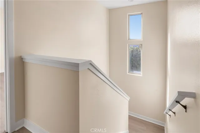 a view of staircase with white walls and white door
