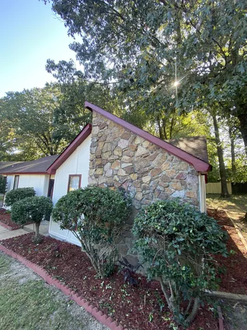 a side view of a house with a yard