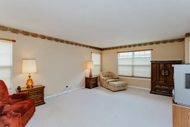 a living room with furniture a window and a lamp