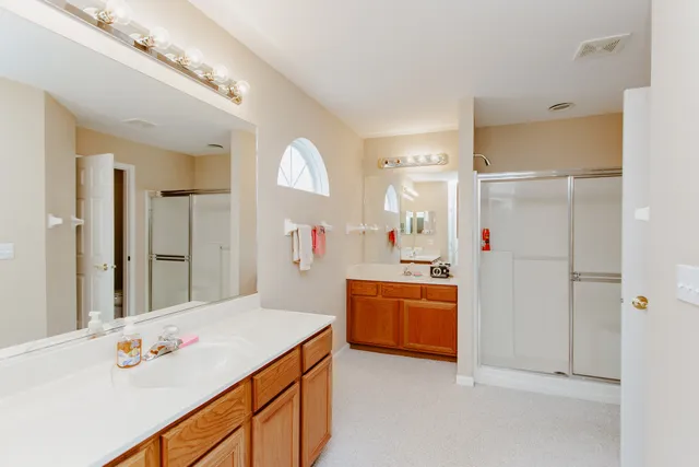 a kitchen with stainless steel appliances kitchen island granite countertop a refrigerator and a sink