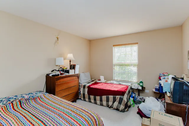 a bedroom with bed and a window