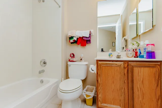 a bathroom with a sink mirror vanity and toilet