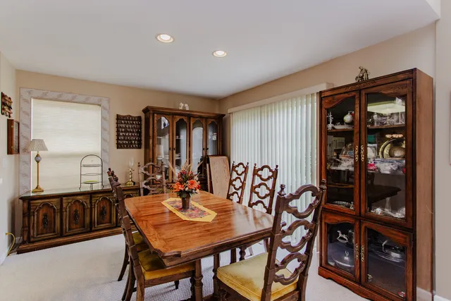 a view of a a dining room with furniture window and wooden floor