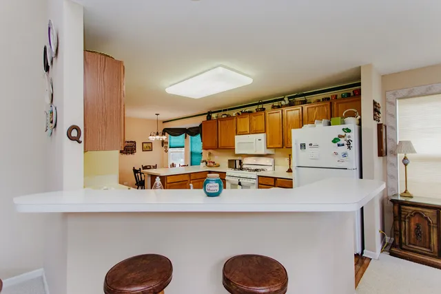 a blue kitchen with a sink a refrigerator and a large window