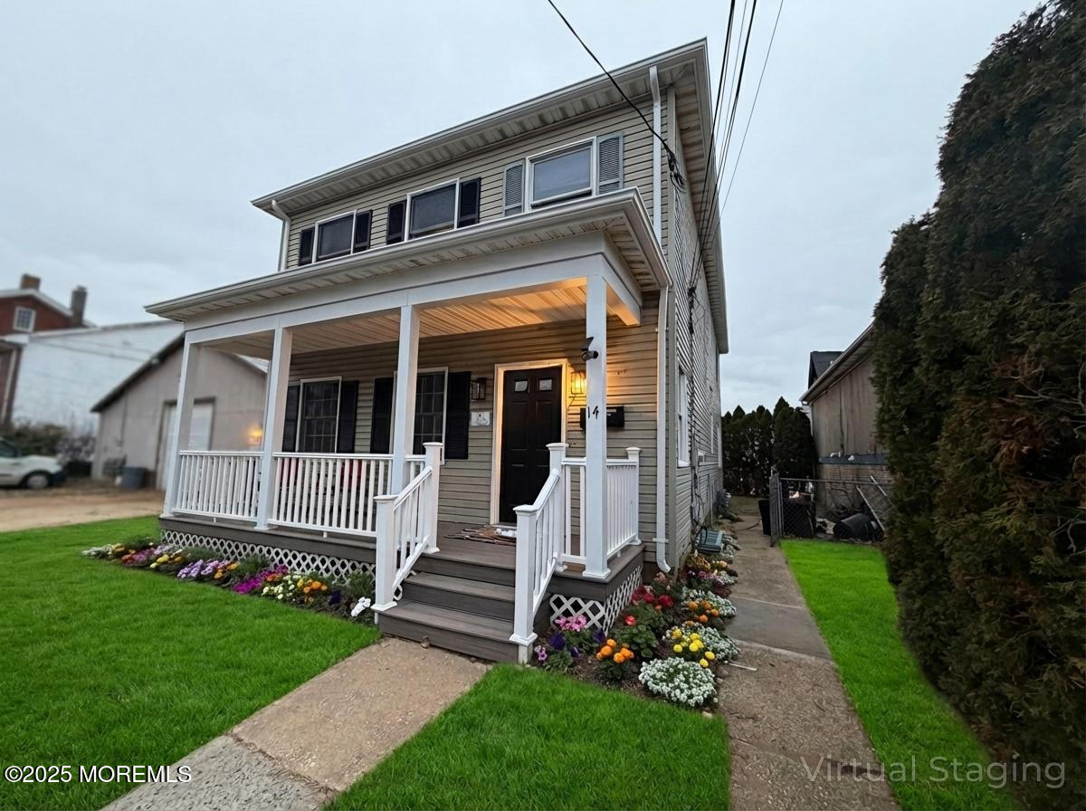 a view of a house with a yard and pathway