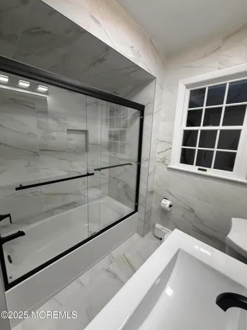 a bathroom with a bathtub and a shower