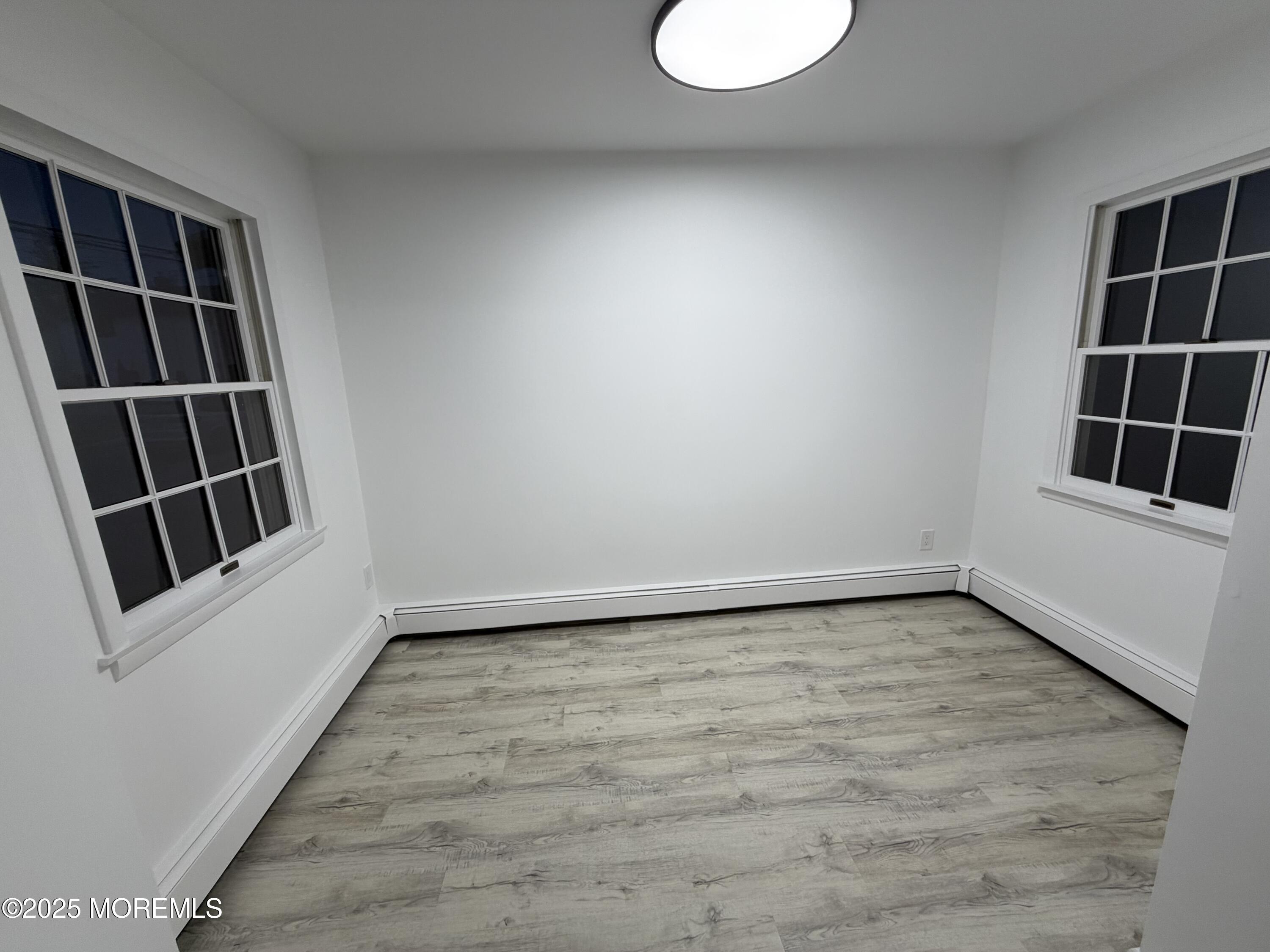14 3rd Street Keyport, NJ 07735 - Photo 14 of 27 a view of an empty room with wooden floor and windows