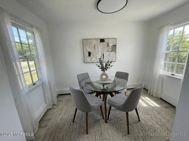 a view of a dining room with furniture and wooden floor