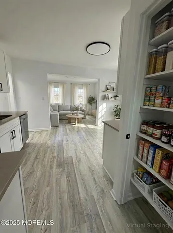a living room with furniture and a book shelf