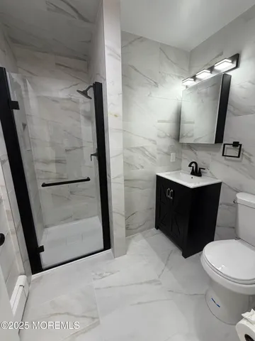 a bathroom with a sink a toilet and mirror