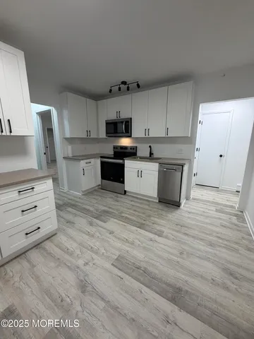a large kitchen with cabinets