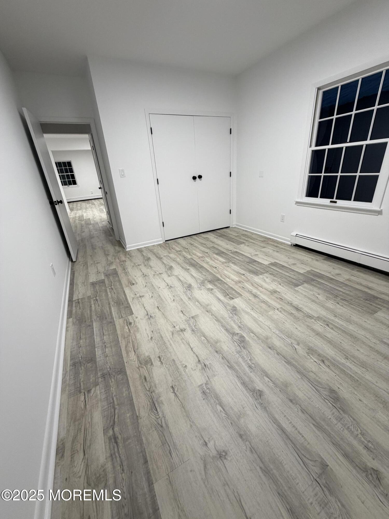 14 3rd Street Keyport, NJ 07735 - Photo 10 of 27 a view of an empty room with wooden floor and stairs