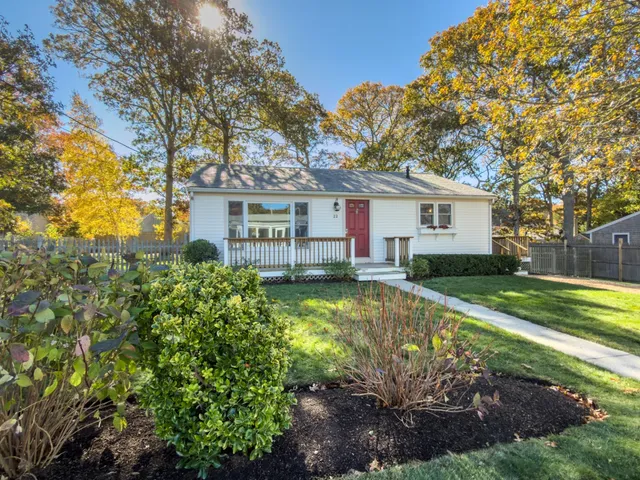 a view of a house with swimming pool next to a yard