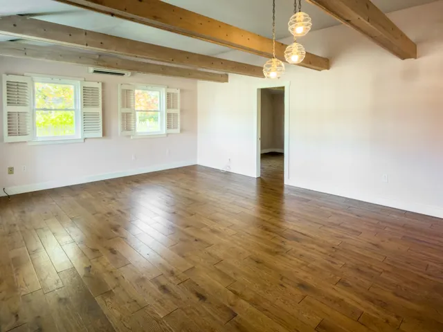 a view of an entryway with wooden floor