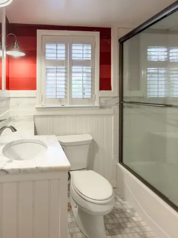 a bathroom with a sink a toilet and shower