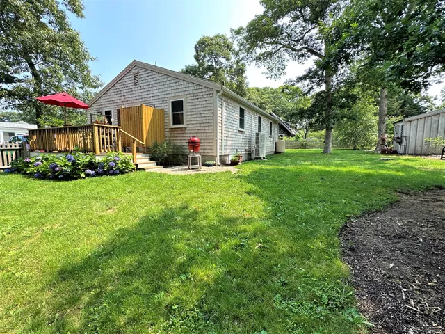 a view of a house with yard and a garden