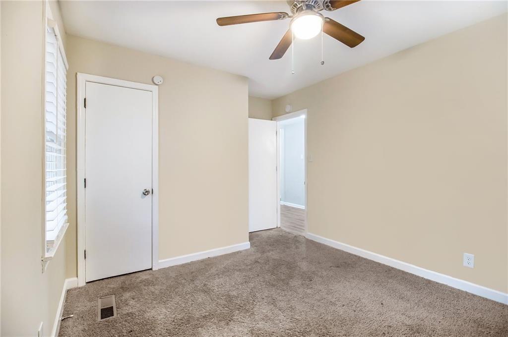 3449 Misty Valley Road Decatur, GA 30032 - Photo 16 of 25 an empty room with closet and a chandelier fan
