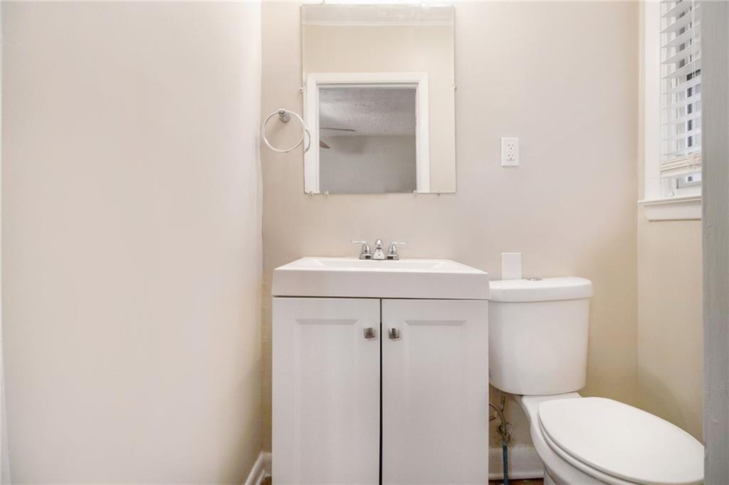 3449 Misty Valley Road Decatur, GA 30032 - Photo 20 of 25 a bathroom with a sink a toilet and a mirror