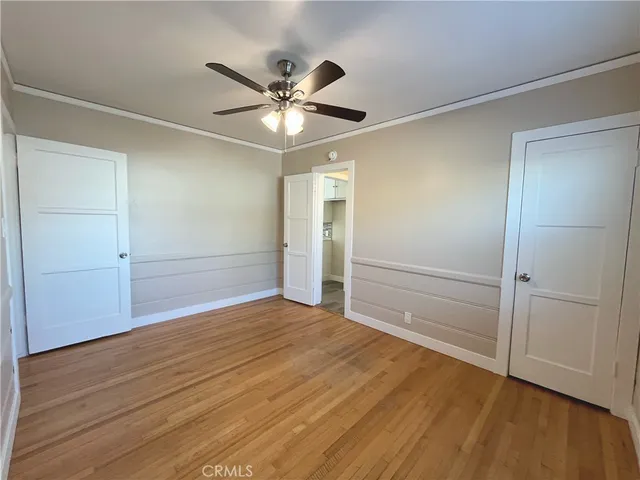 a view of an empty room and wooden floor