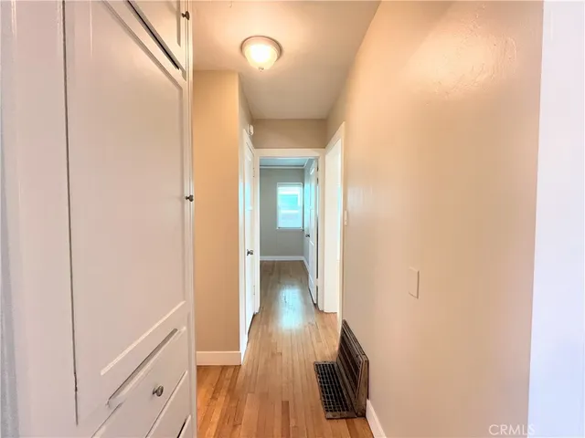 a view of hallway with wooden floor