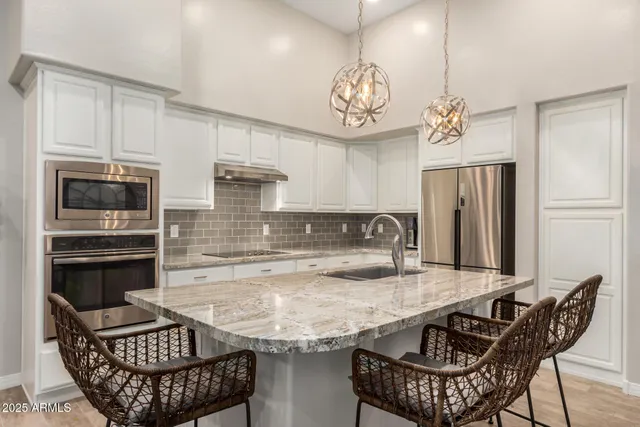 a kitchen with a table chairs and microwave