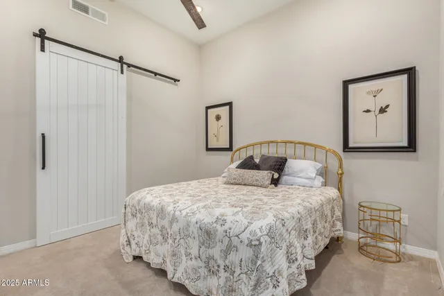 a bedroom with a bed and a table