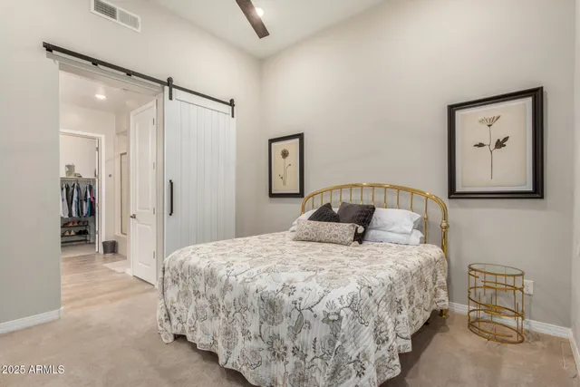 a bedroom with a bed and a painting