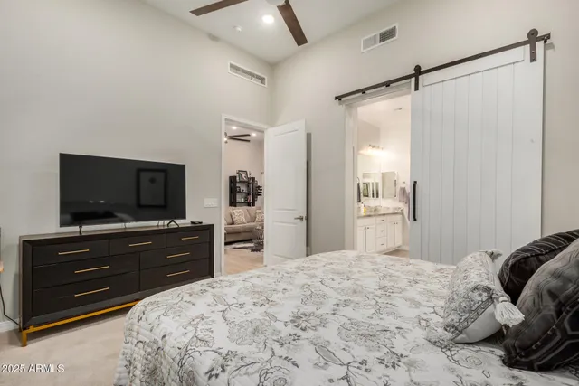 a bedroom with a bed and a flat screen tv