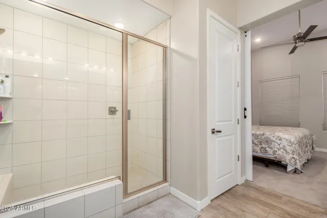 a bathroom with a shower and a glass door