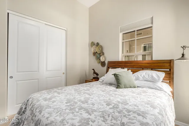 a bedroom with a large bed and a window