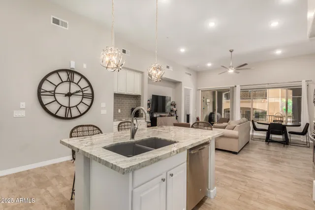 a kitchen with a table chairs and a clock