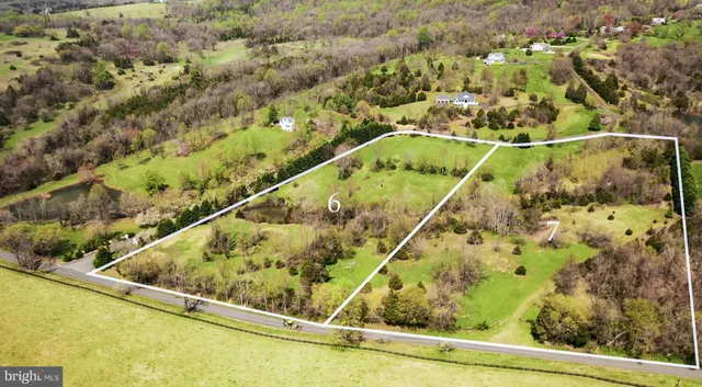 an aerial view of a forest with houses