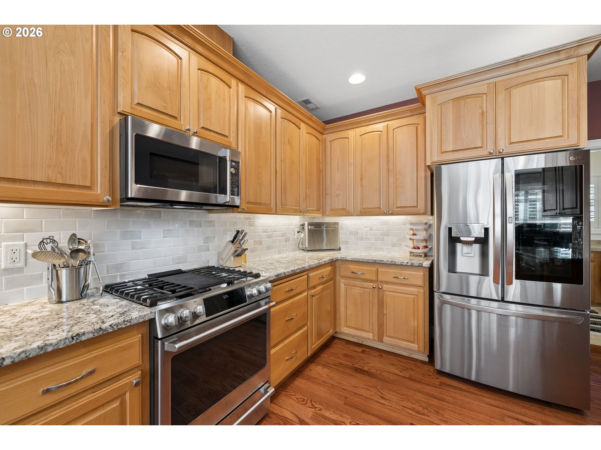 945 Northwest Angel Heights Road Stevenson, WA 98648 - Photo 13 of 41 a kitchen with granite countertop a stove top oven microwave and refrigerator