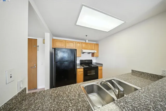 a kitchen with a sink and a refrigerator
