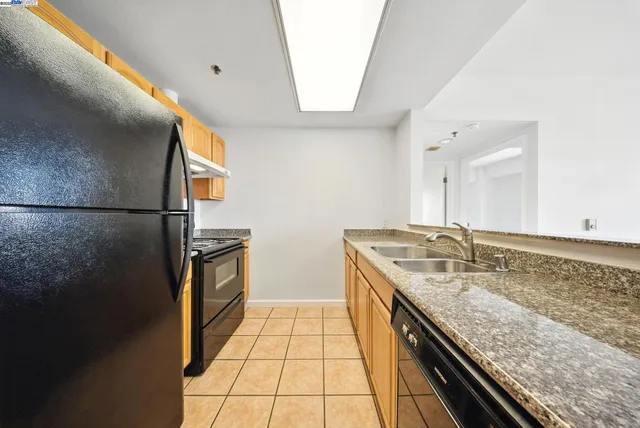 a kitchen with a stove and a refrigerator