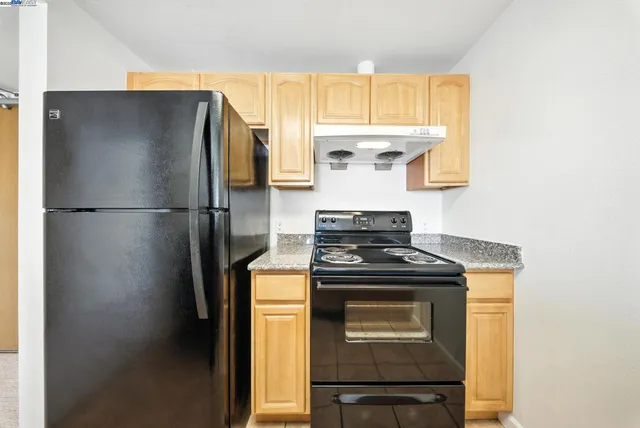 a bathroom with a bathtub shower sink mirror vanity and toilet