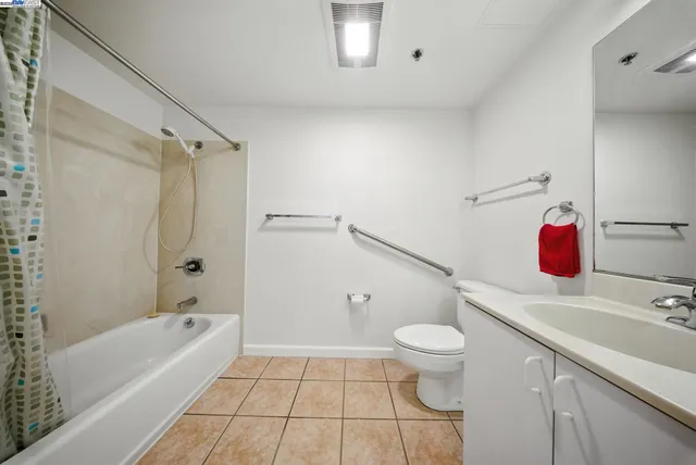 a bathroom with a tub shower and a sink