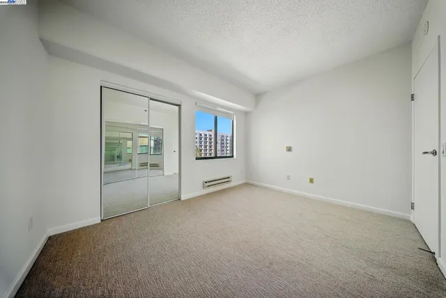 an aerial view of multi story residential apartment building with a yard