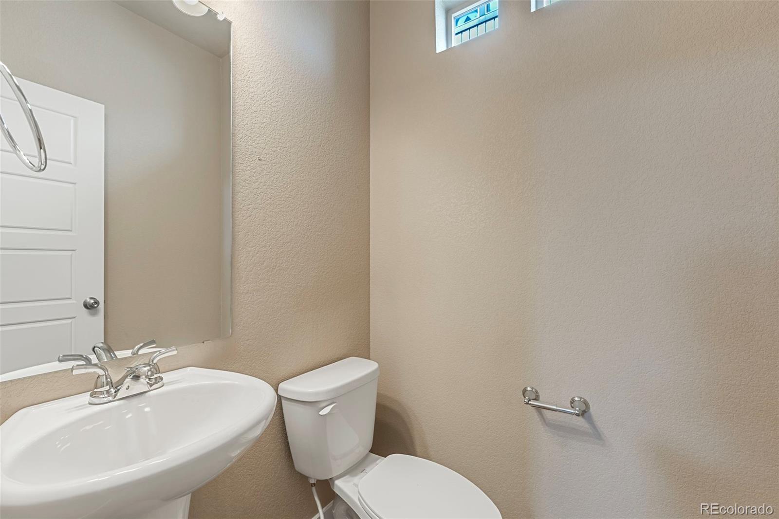 9528 Timberlake Loop Colorado Springs, CO 80927 - Photo 19 of 37 a white toilet sitting next to a white sink