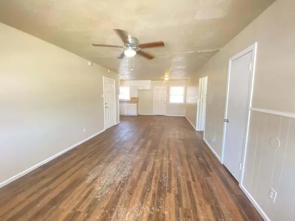 a view of a hallway with wooden floor