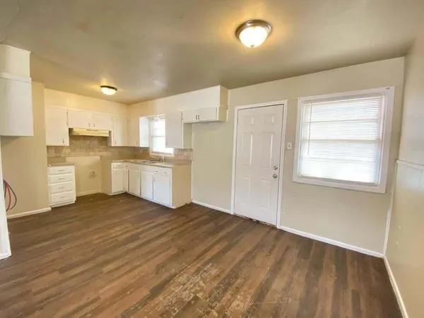 a view of a kitchen with wooden floor