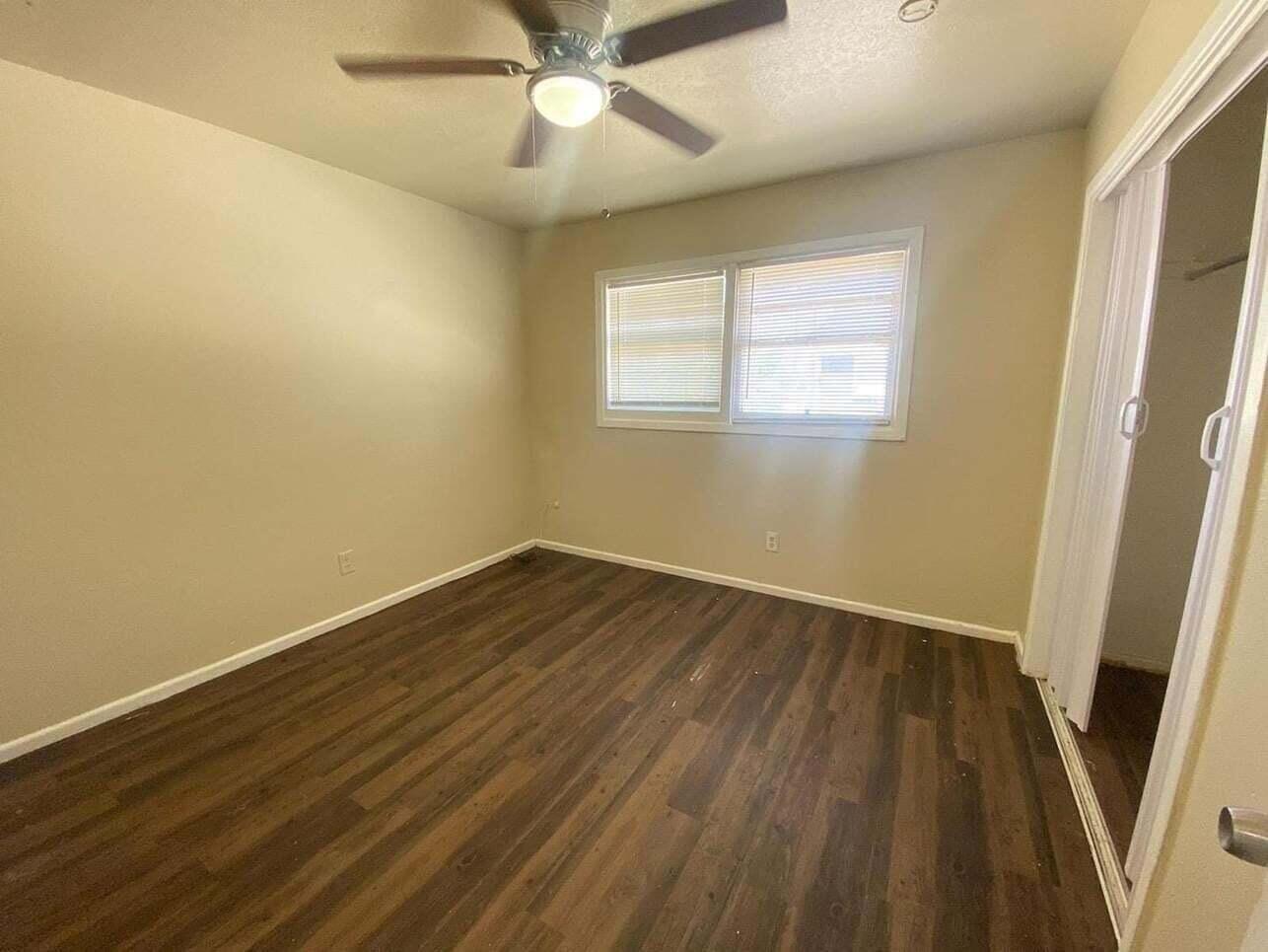 1710 East Dartmouth Street Lubbock, TX 79403 - Photo 4 of 6 a view of an empty room with wooden floor and a window