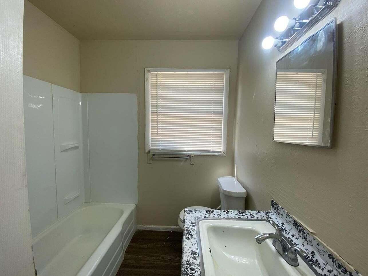 1710 East Dartmouth Street Lubbock, TX 79403 - Photo 5 of 6 a bathroom with a sink a vanity and a bathtub
