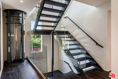 a view of entryway with wooden floor and stairs