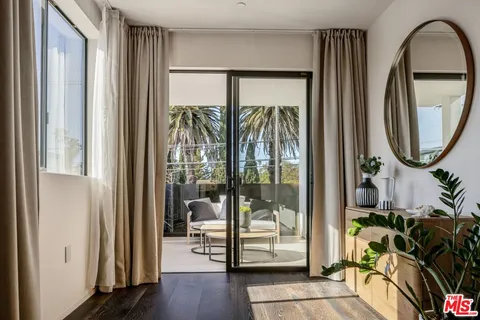 a view of a bathroom with mirror and furniture