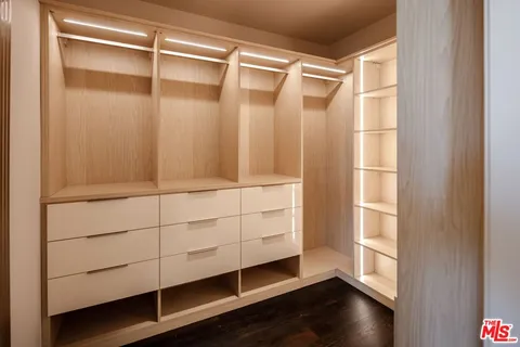 a bedroom with a bed a couch and a flat screen tv